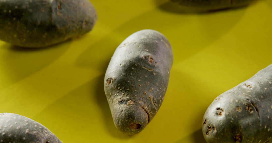 Raw Purple Potatoes on Yellow Background - Free Images, Stock Photos and Pictures on Pikwizard.com