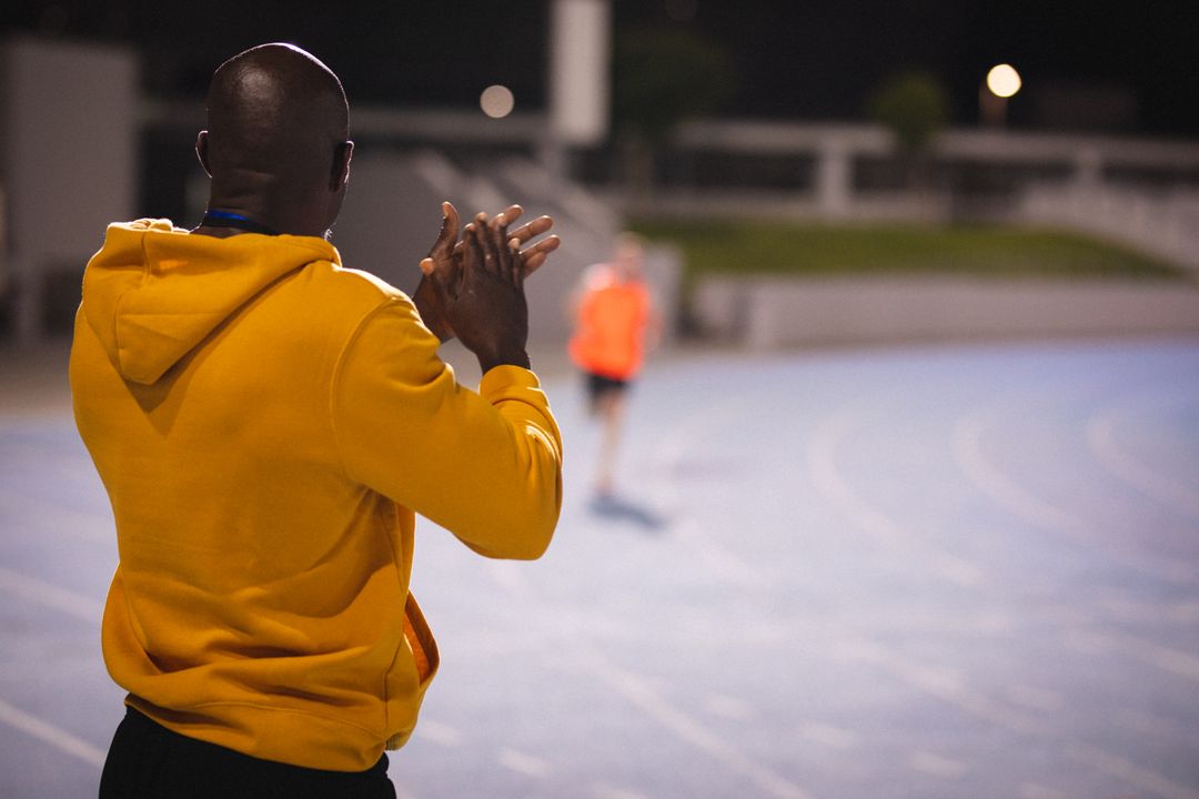 Back view of african american male coach with clapping hands during training - Free Images, Stock Photos and Pictures on Pikwizard.com