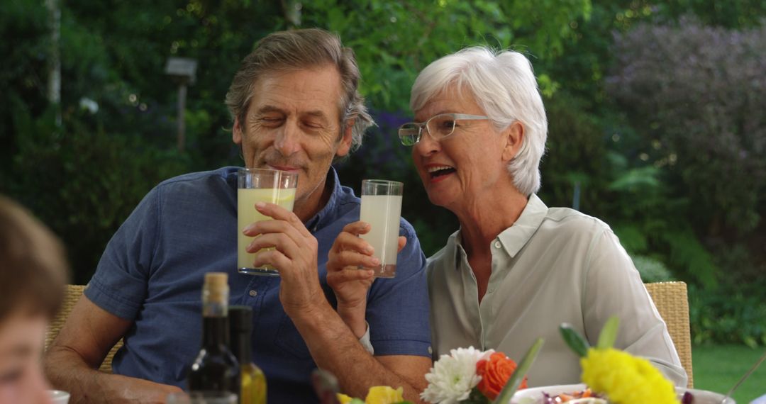 Joyful Grandparents Enjoying Refreshing Drinks Together