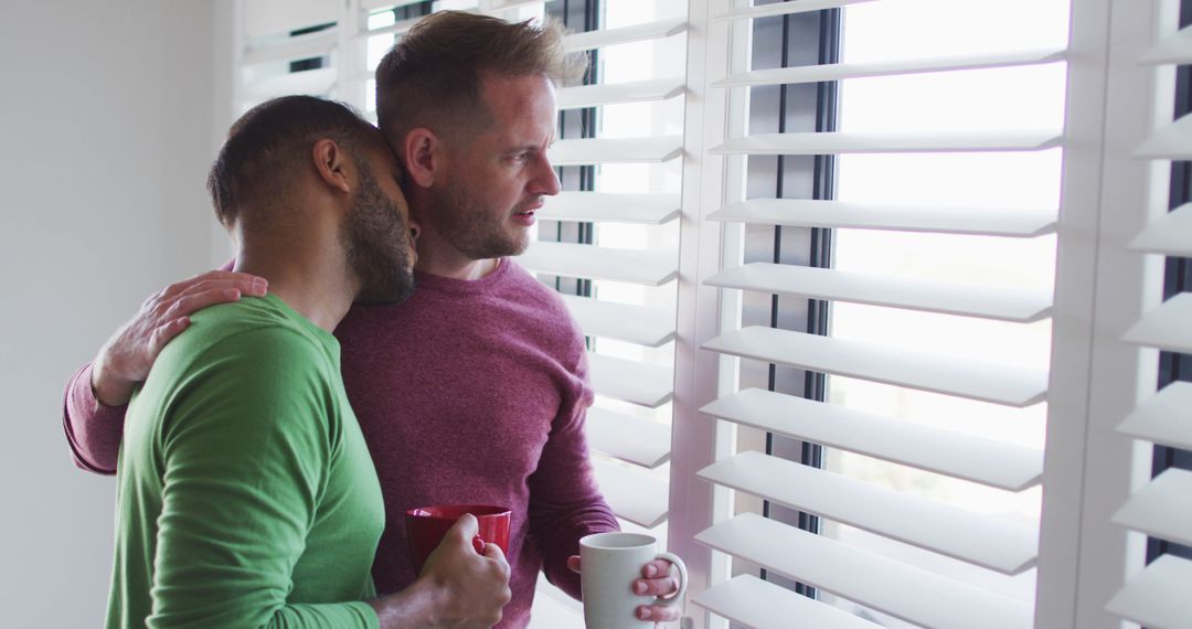 Multi ethnic gay male couple drinking coffee and talking - Free Images, Stock Photos and Pictures on Pikwizard.com