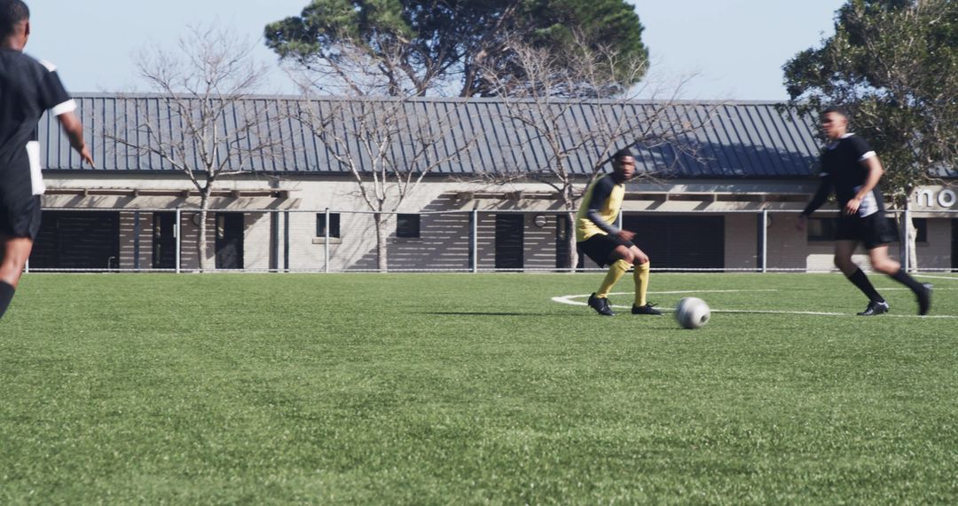 Soccer Players Practicing on Field Emphasizing Agility and Teamwork