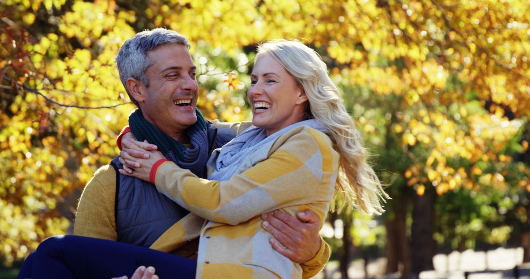 Happy mature couple enjoying autumn day in park - Free Images, Stock Photos and Pictures on Pikwizard.com