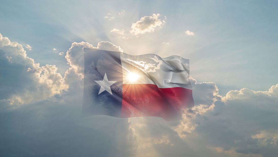 Texas Flag Floating in Radiant Cloudy Sky