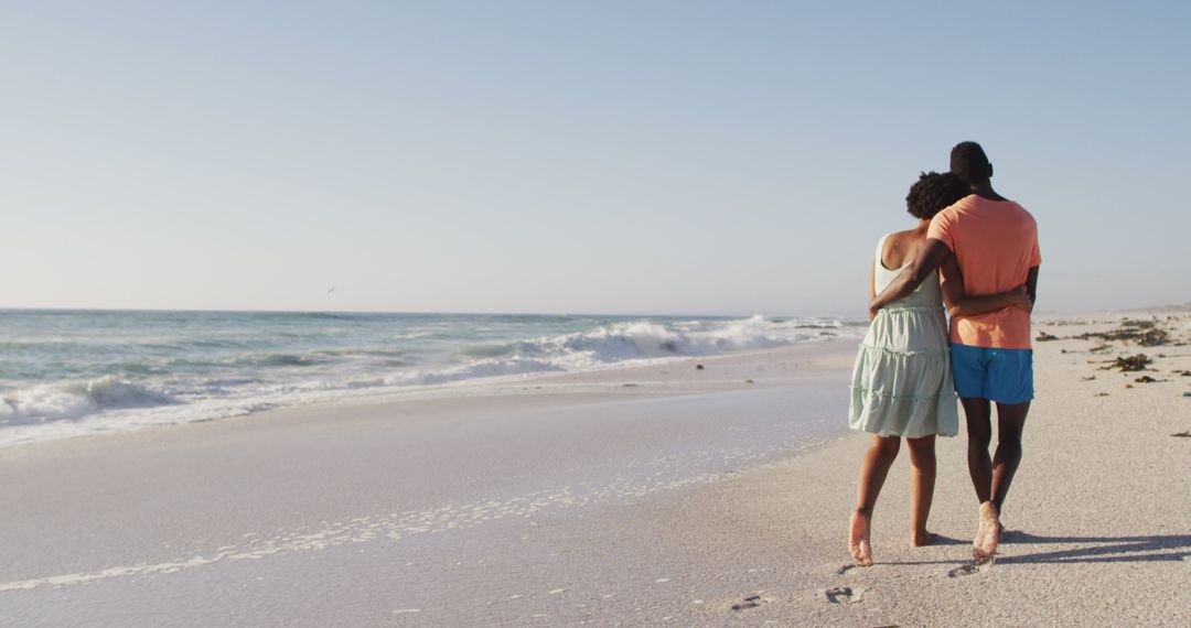 Romantic Couple Walking on Beach Hugging - Free Images, Stock Photos and Pictures on Pikwizard.com