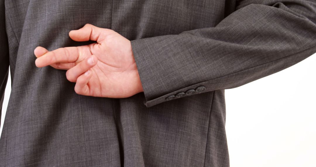 Businessman Crossing Fingers Behind Back Symbolizing Deception