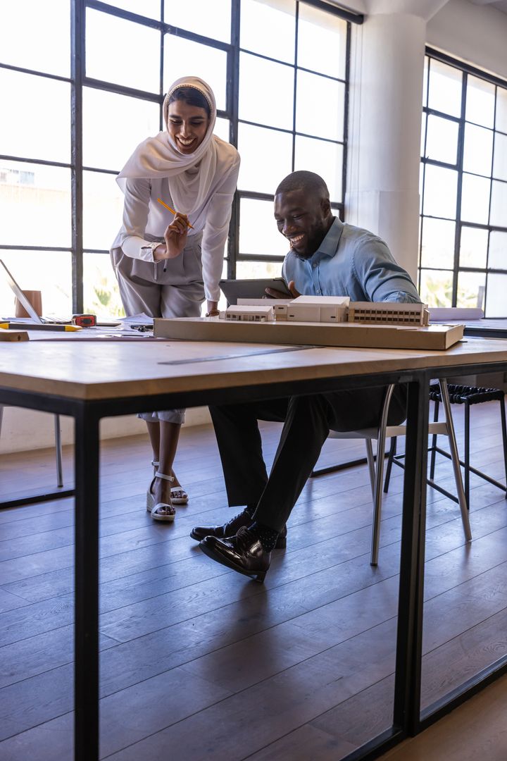 Diverse Colleagues Discussing Scale Model in Architecture Studio