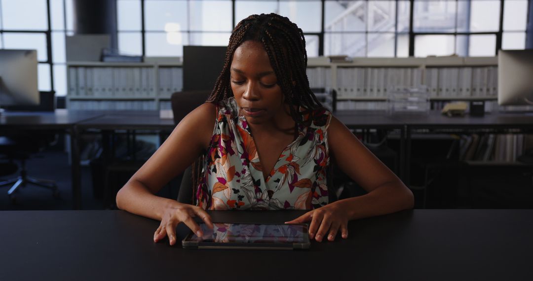 Focused Professional Utilizing Tablet in Modern Corporate Office