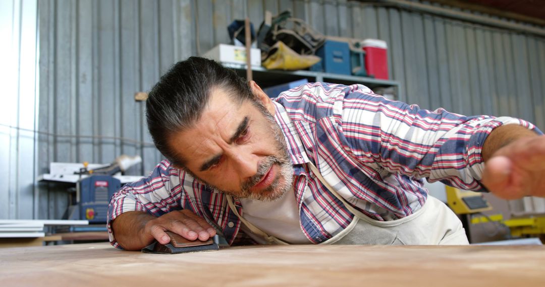 Carpenter Focusing on Sanding Wooden Surface in Workshop - Free Images, Stock Photos and Pictures on Pikwizard.com