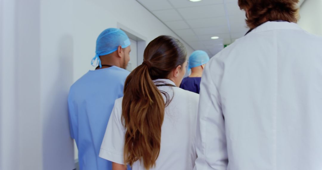 Medical Team Walking Down Hospital Corridor - Free Images, Stock Photos and Pictures on Pikwizard.com