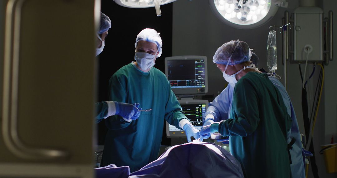 Image of diverse male assistant and female surgeons operating on patient in operating theatre - Free Images, Stock Photos and Pictures on Pikwizard.com