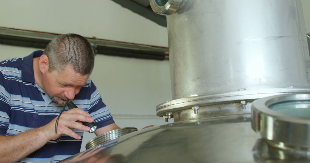 Brewmaster Inspecting Fermentation Tank in Brewery - Free Images, Stock Photos and Pictures on Pikwizard.com