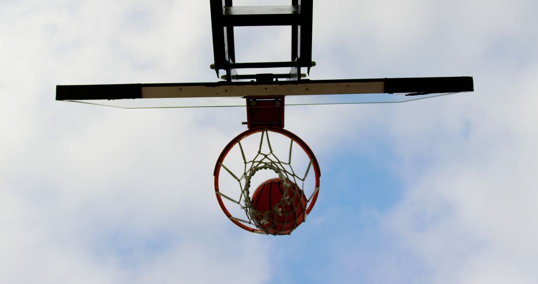 Basketball Hoop with Ball in Basket Against Sky - Free Images, Stock Photos and Pictures on Pikwizard.com