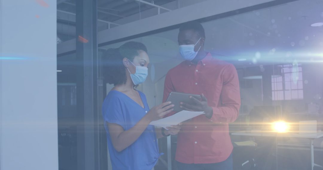 Collaboration between Colleagues in Modern Office Setting with Light Effects