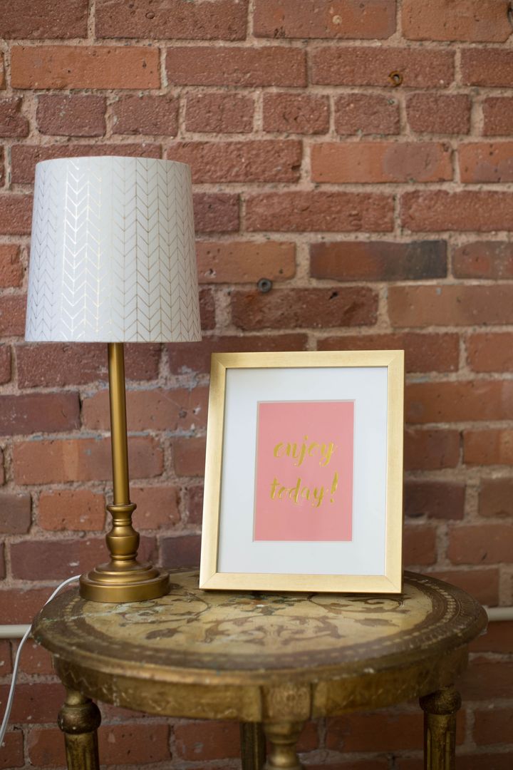 Vintage Brass Lamp and Inspirational Print on Wood Table