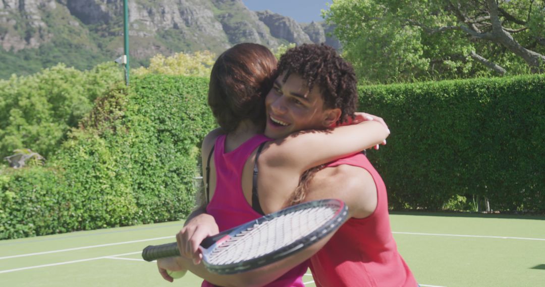 Two Female Friends Hugging on Outdoor Tennis Court - Free Images, Stock Photos and Pictures on Pikwizard.com