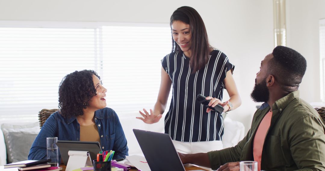 Cheerful Multicultural Team Collaborating at Home Workspace