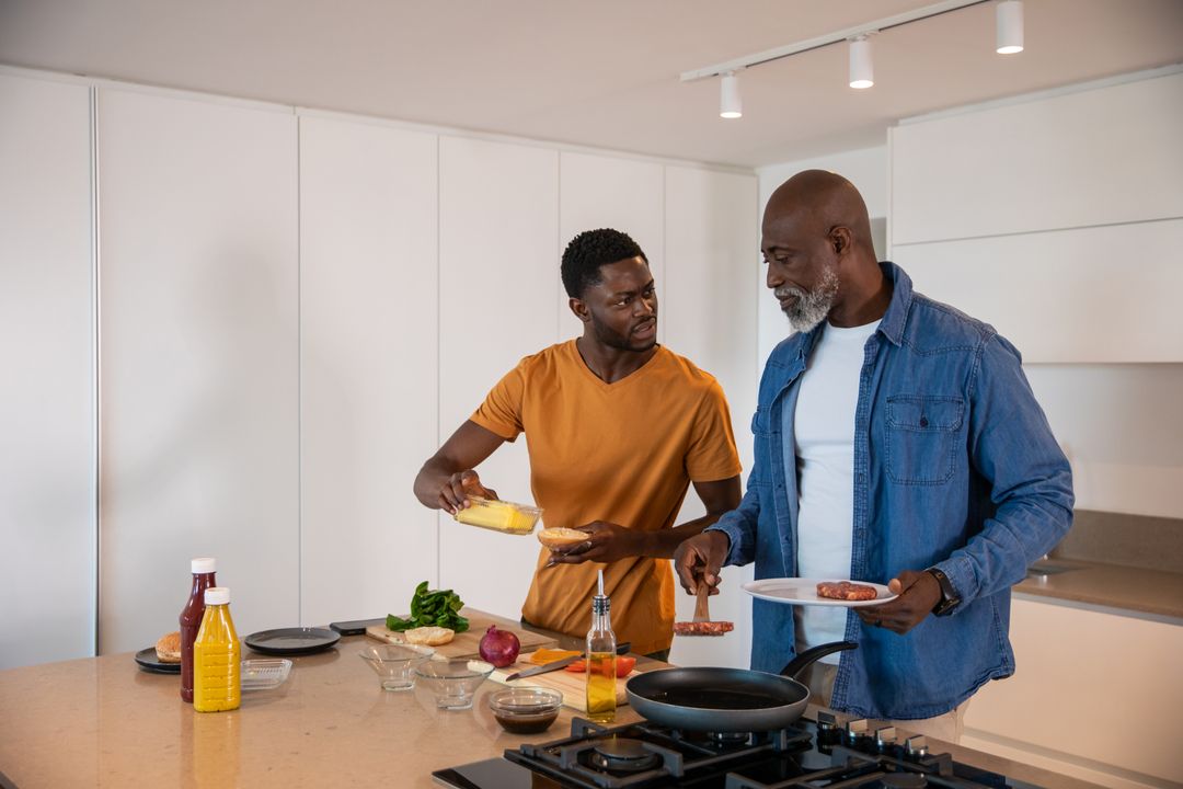 Father and Son Cooking Breakfast in Modern Kitchen