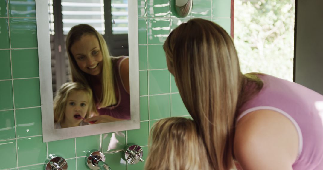 Mother Assisting Daughter with Dental Hygiene at Home - Free Images, Stock Photos and Pictures on Pikwizard.com