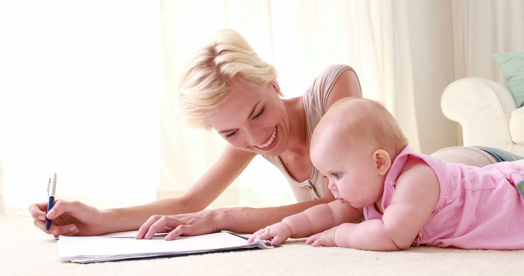 Mother and Baby Drawing Together on Floor - Free Images, Stock Photos and Pictures on Pikwizard.com