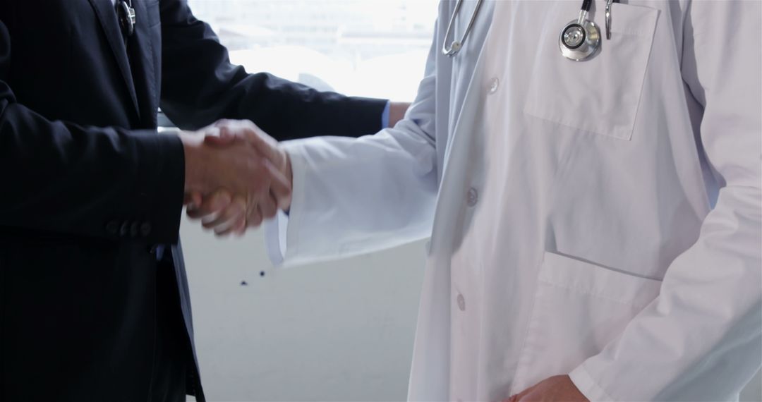 Doctor in White Coat Shaking Hands with Associate - Free Images, Stock Photos and Pictures on Pikwizard.com