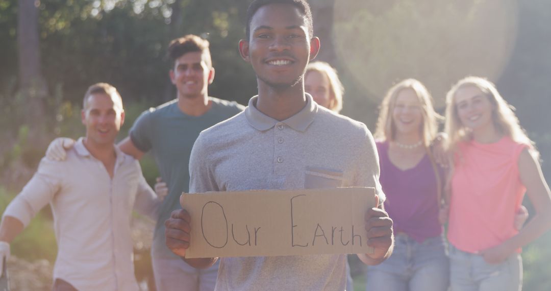 Diverse Group of Young Eco-Activists Holding 'Our Earth' Sign Outdoors - Free Images, Stock Photos and Pictures on Pikwizard.com