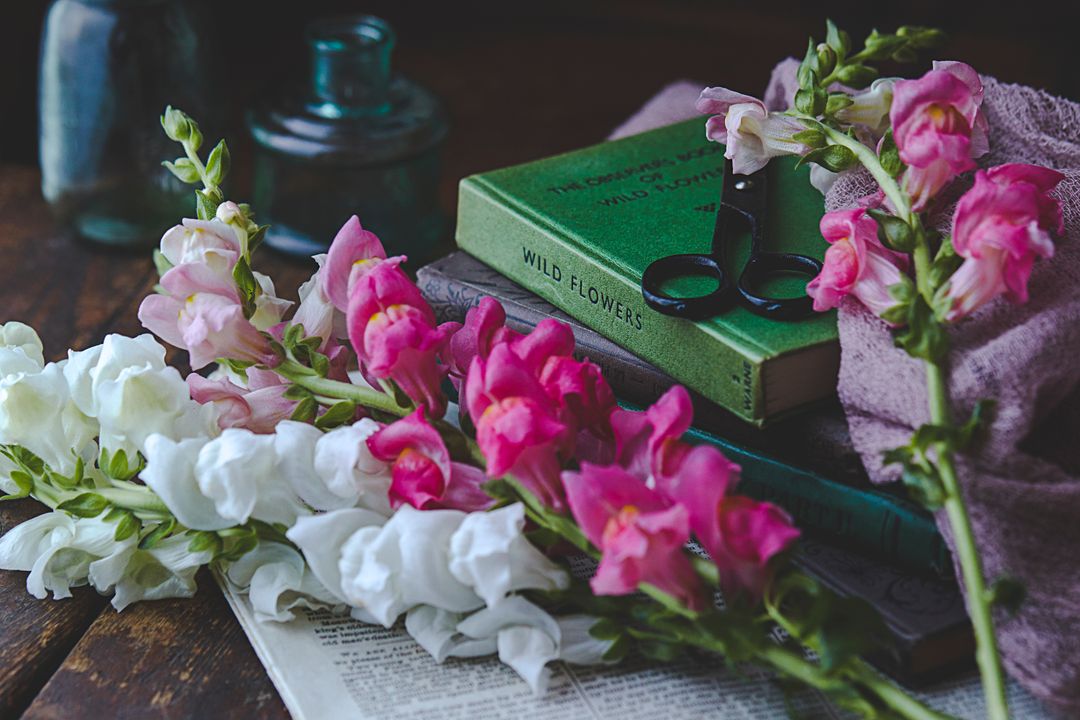 Vintage Books and Snapdragons on Rustic Wood Table