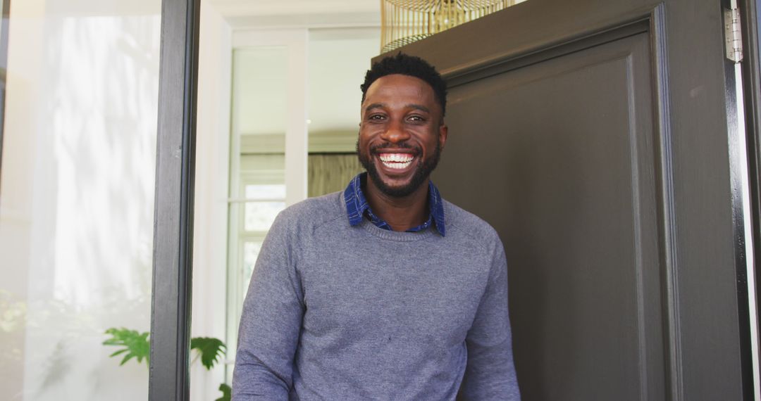 Welcoming Man Standing at Doorway Smiling Warmly