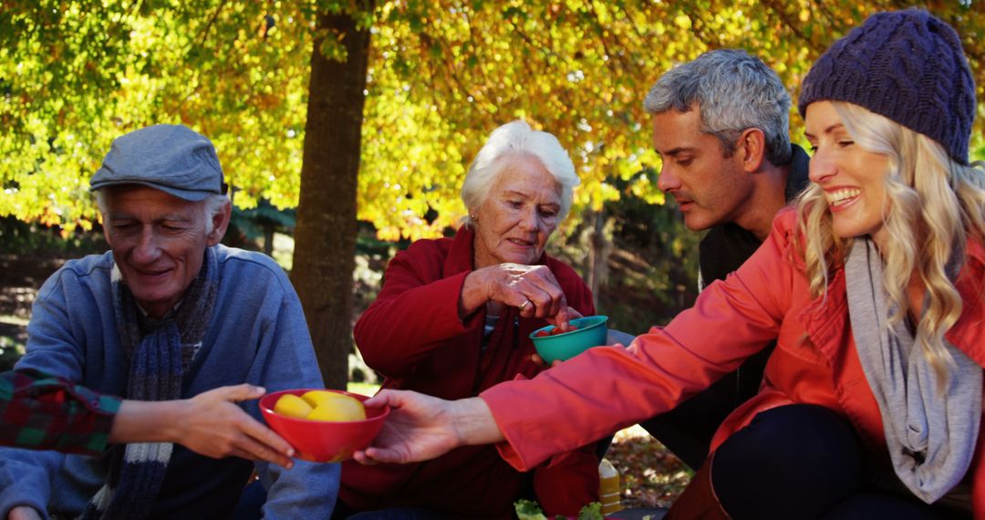 Family Enjoying Picnic Outdoors in Autumn Park - Free Images, Stock Photos and Pictures on Pikwizard.com