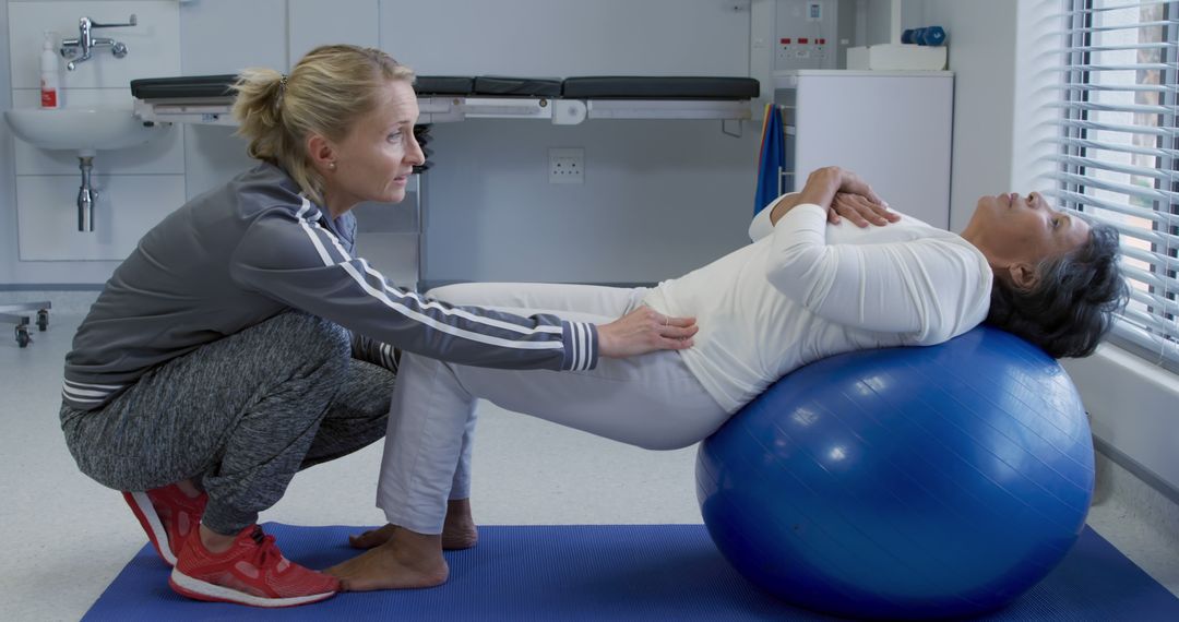 Physiotherapist Assisting Senior Woman During Exercise Session - Free Images, Stock Photos and Pictures on Pikwizard.com