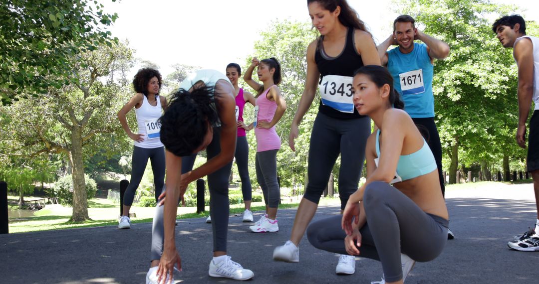 Group of Young Athletes Stretching After Running Event in Park - Free Images, Stock Photos and Pictures on Pikwizard.com