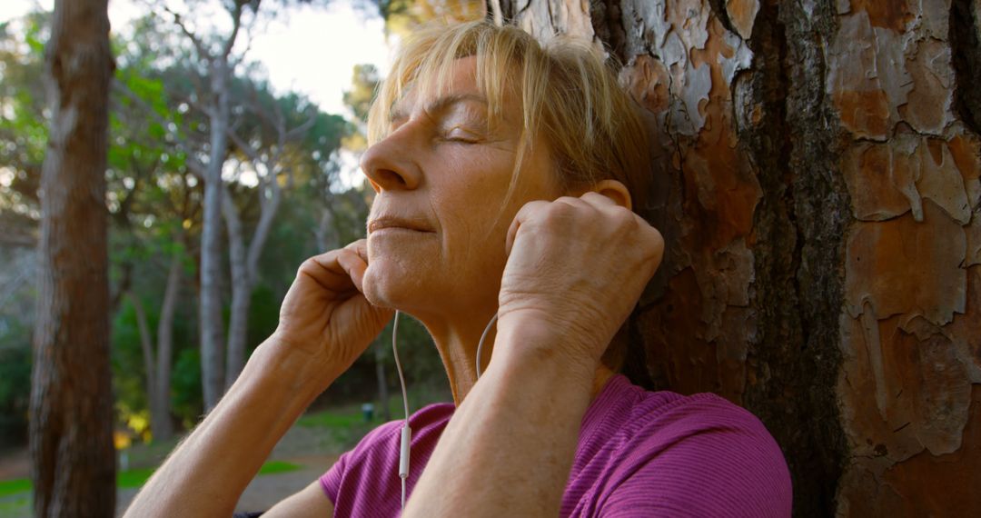 Elderly Woman Meditating by Tree in Forest - Free Images, Stock Photos and Pictures on Pikwizard.com