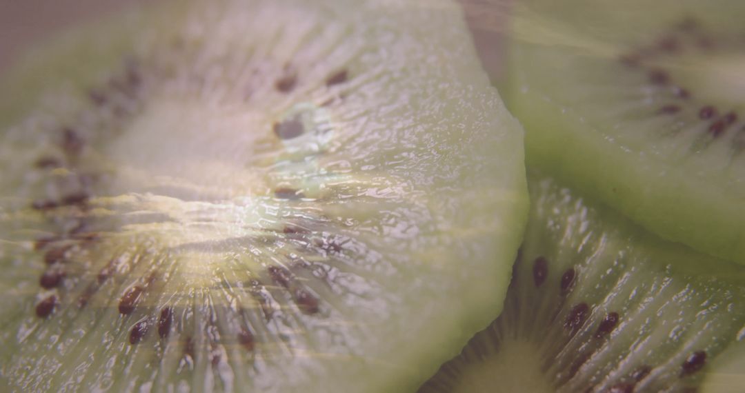 Macro View of Fresh Kiwi Fruit Slices Spotlighting Vibrant Seed Patterns