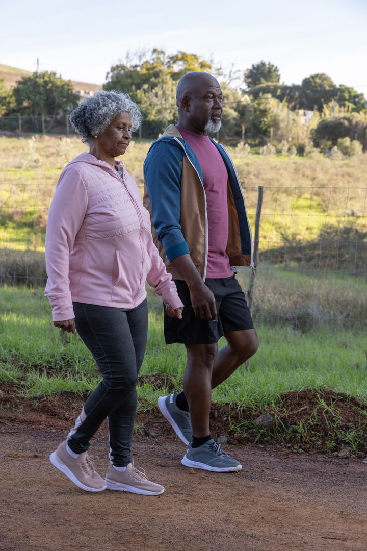 Senior Couple Walking on Trail Enjoying Nature and Togetherness