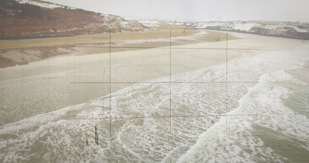 Snow-Covered Hills Overlooking Waves on Sandy Coastline