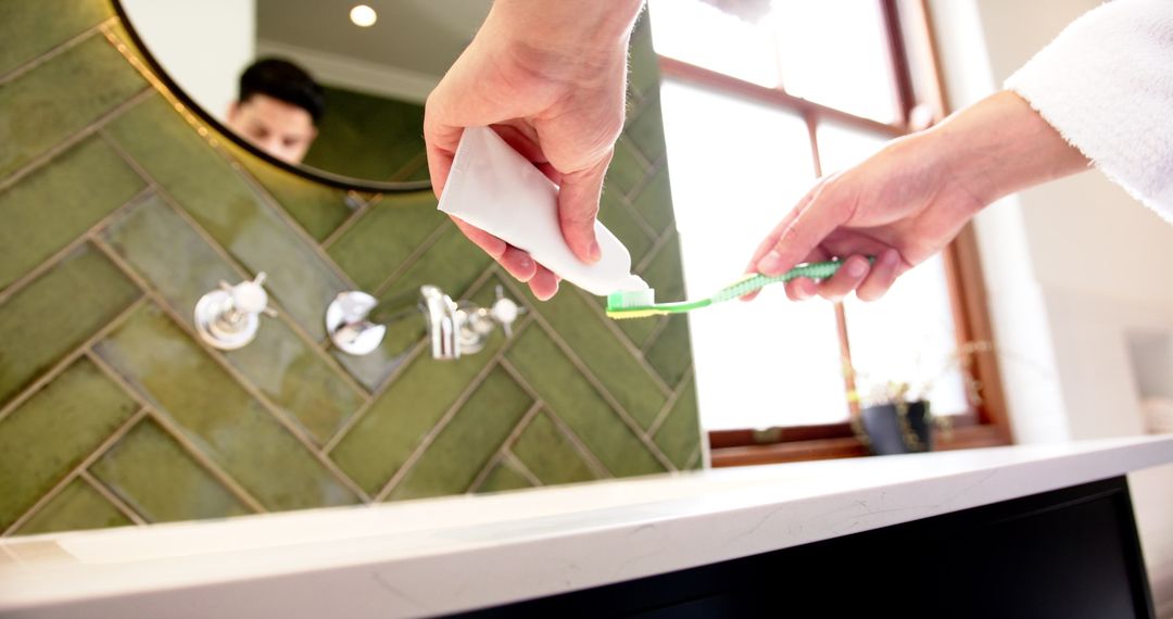 Morning Routine: Applying Toothpaste to Toothbrush in Comfortable Bathroom