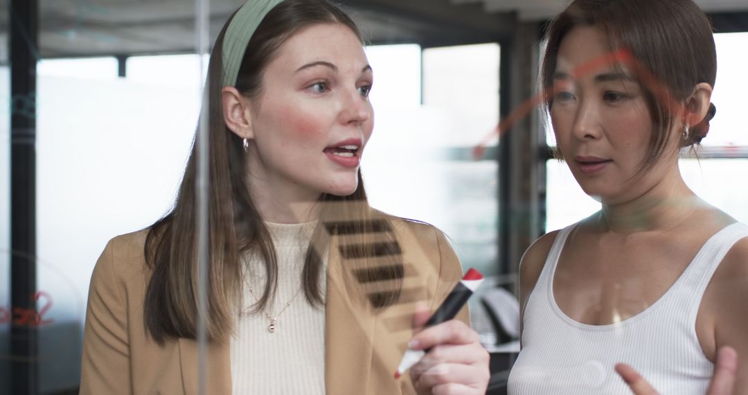 Young and Senior Colleagues Discussing Project Insights in Office