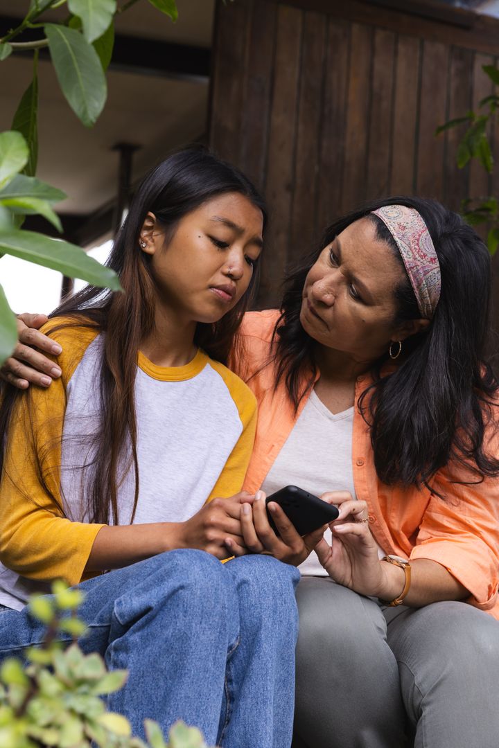 Supportive Mother and Daughter Sharing a Moment Outside