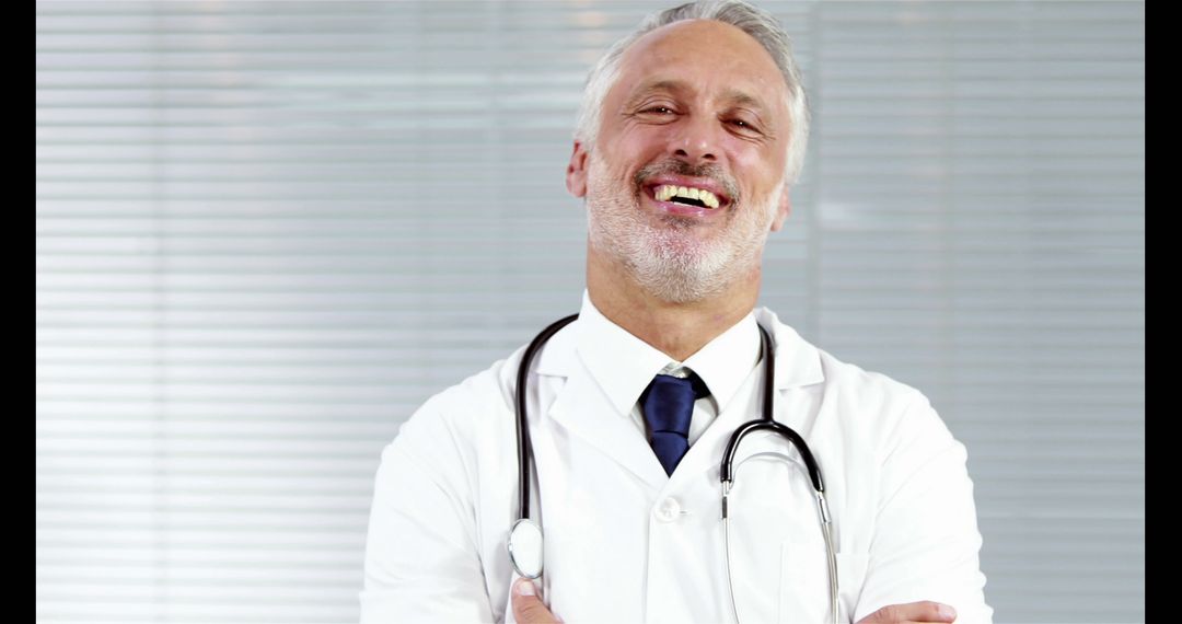 Confident Senior Male Doctor Smiling with Stethoscope - Free Images, Stock Photos and Pictures on Pikwizard.com