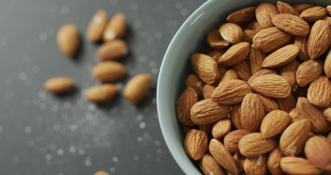 Bowl of Fresh Almonds on Minimalistic Grey Background
