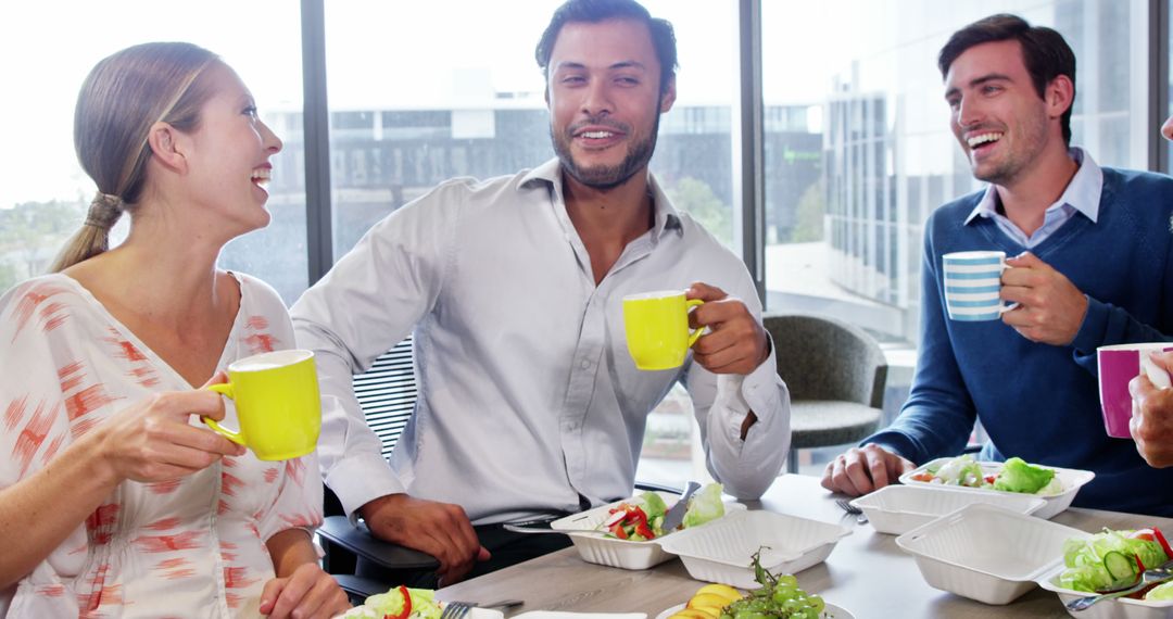 Business Colleagues Sharing Breakfast and Laughter in Modern Office