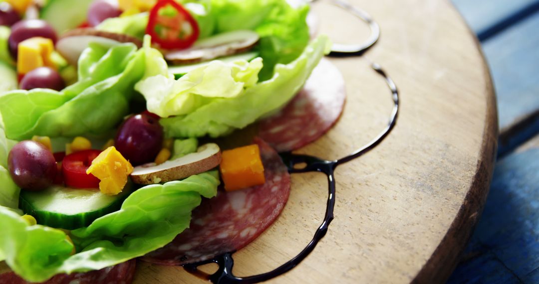 Fresh Salad with Lettuce, Grapes, and Salami on Wooden Board - Free Images, Stock Photos and Pictures on Pikwizard.com