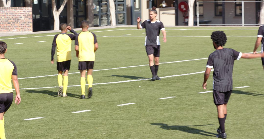 Team in Yellow Uniform Practicing Soccer on Field