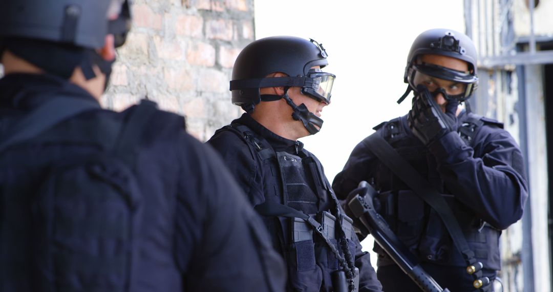 Police officers in tactical gear discussing strategy - Free Images, Stock Photos and Pictures on Pikwizard.com