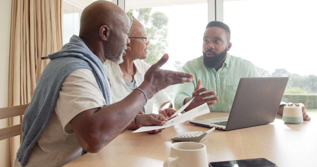 Senior couple consulting with financial advisor in modern home