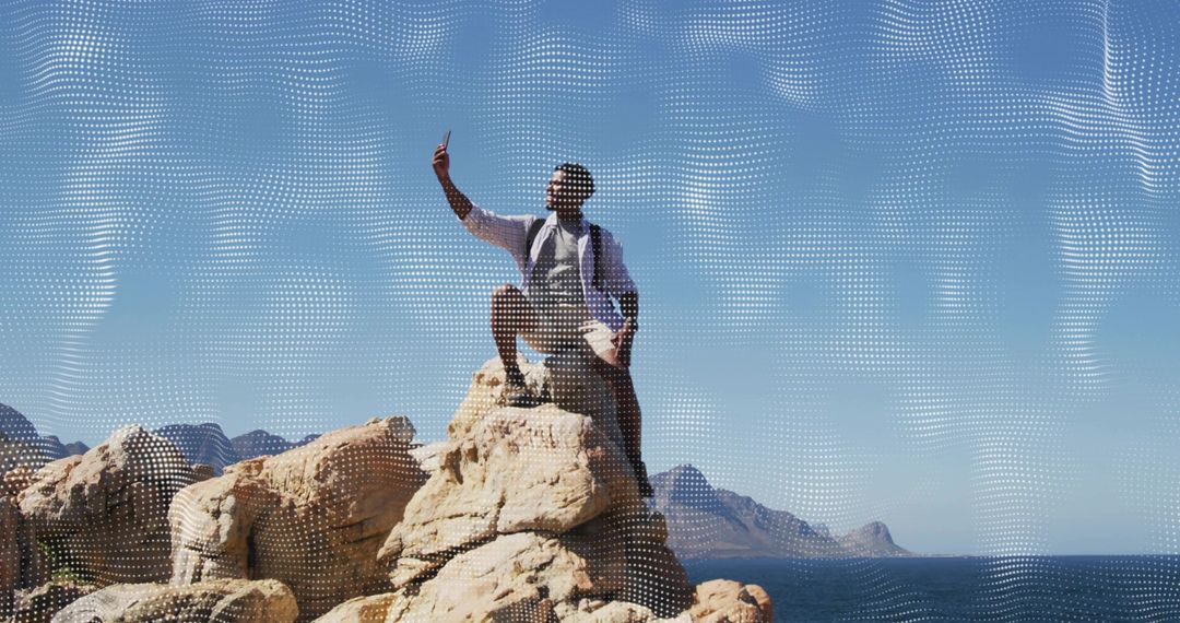 Hiker Capturing Selfie on Rocky Coastal Outcrop While Backpacking Along Ocean Horizon