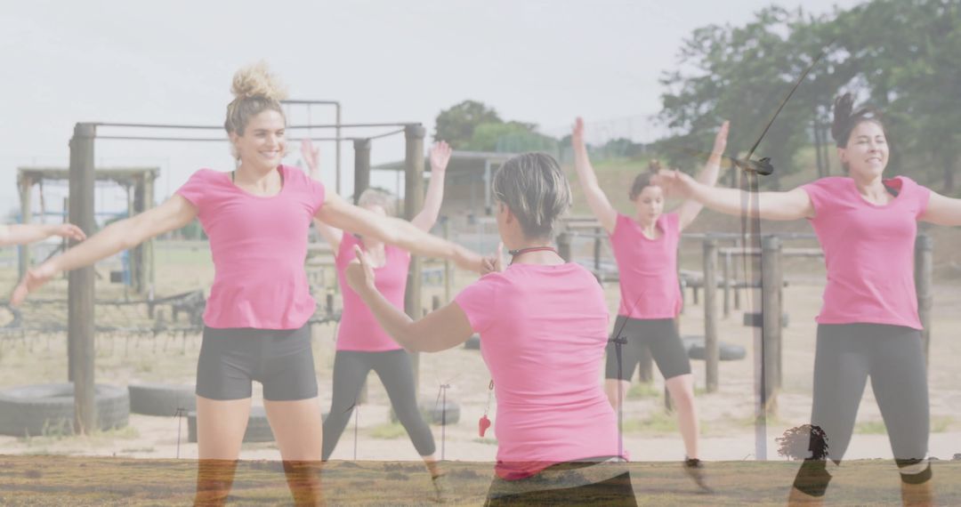 Female Fitness Class Exercising at Outdoor Gym with Instructor