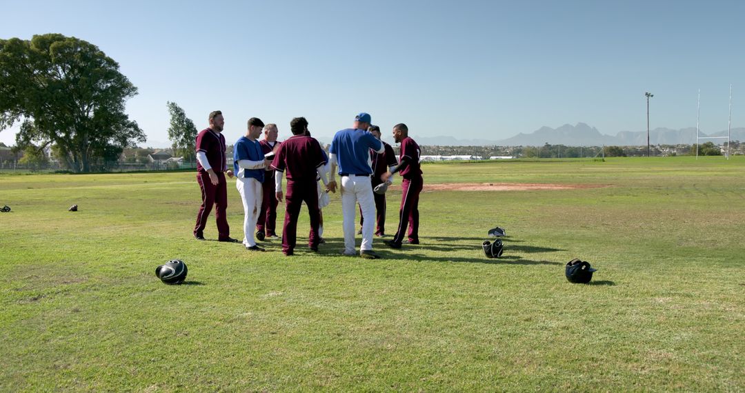 Diverse Baseball Teammates Huddling on Sunny Field