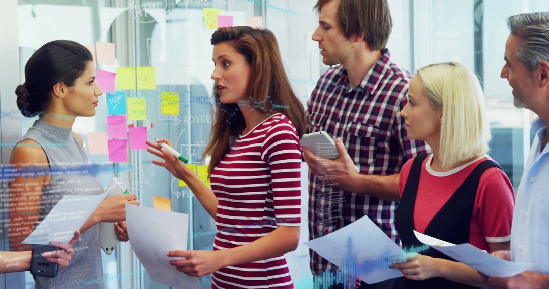 Diverse Team Planning with Sticky Notes and Technology in Modern Office