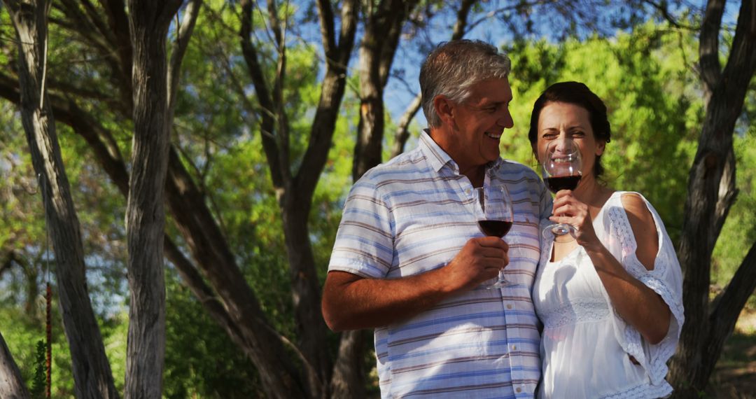 Middle-Aged Couple Enjoying Wine in Peaceful Nature