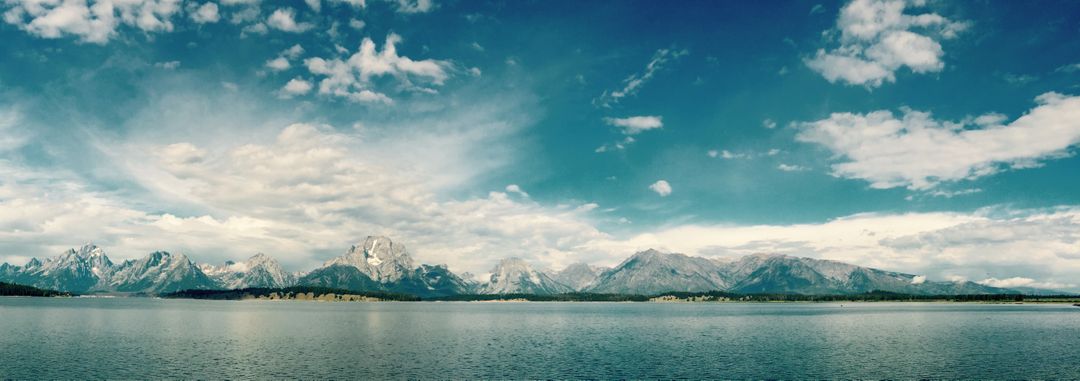 Panoramic View of Majestic Mountain Range and Clear Lake under Blue Sky - Free Images, Stock Photos and Pictures on Pikwizard.com